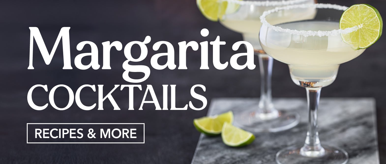 Two Refreshing Margarita Cocktails with salted rim and lime