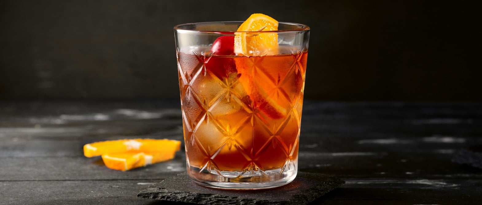 Craft-made Old Fashioned Bourbon whiskey cocktail with an orange peel in a rocks glass