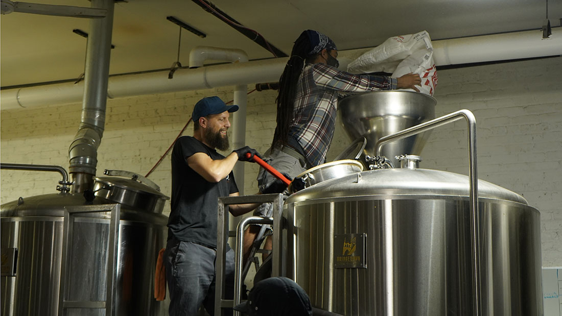 Head Brewer Roger stirring mash.JPG
